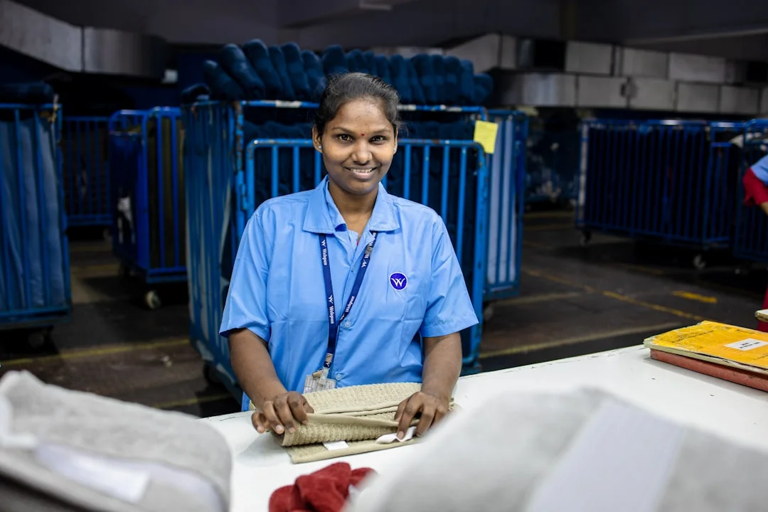 A person sanitizes a workspace by fumigation while wearing full protective equipment for protection and safety.